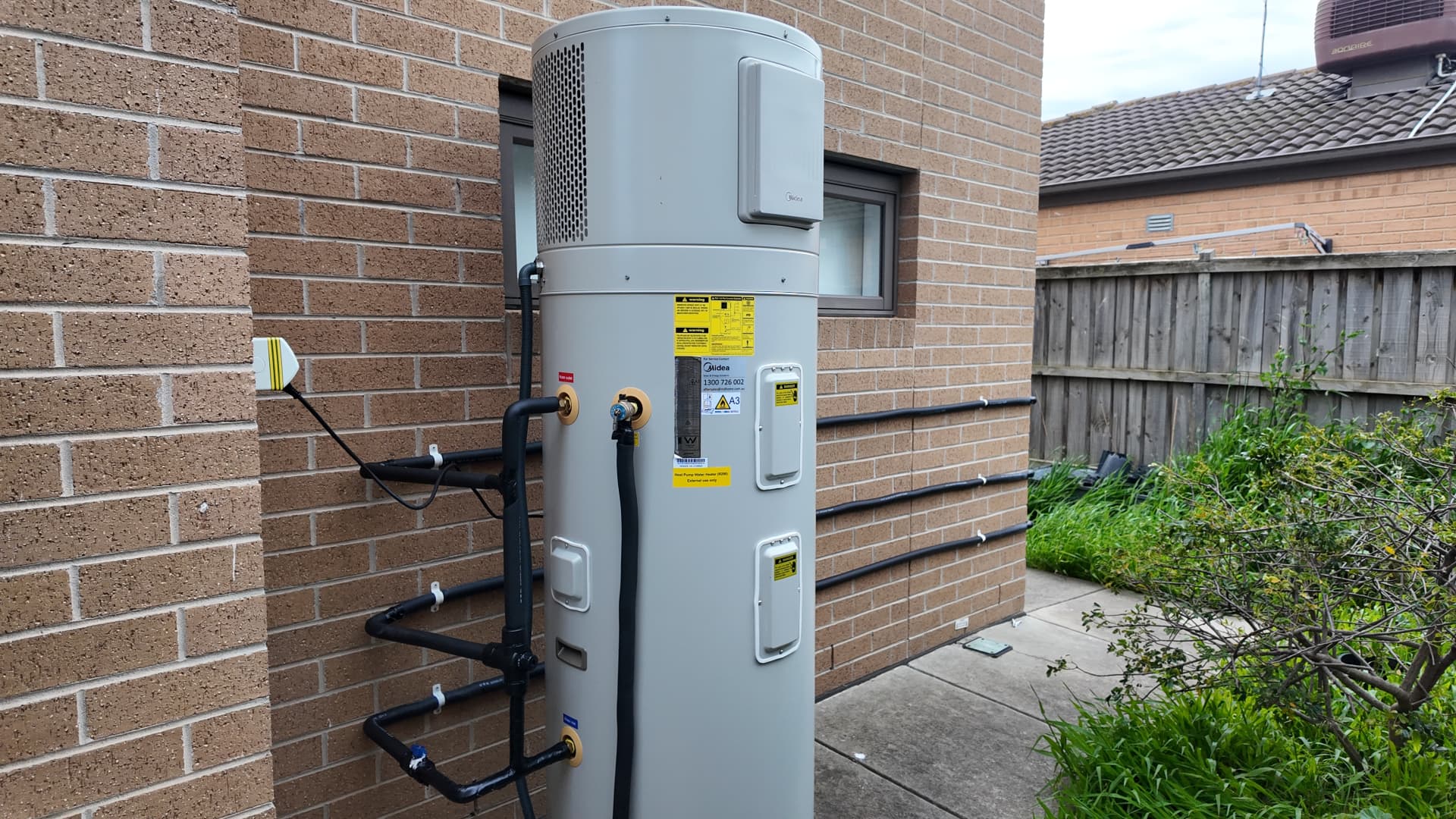 Heat pump hot water system installed beside a Melbourne home